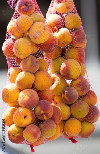 Canvas Print Group of Peaches in bags on sale hanging in a retail shop