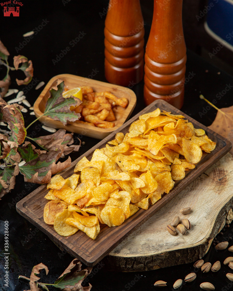 potatoes chips and spice grinders on the table