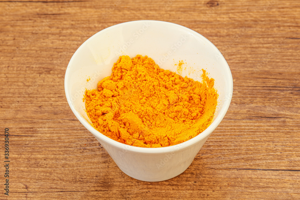 Tumeric powder in the bowl Tumeric powder in the bowl