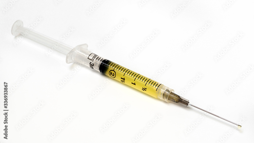 Vaccine contained in a syringe on a white background. Vaccine contained in a syringe on a white background.