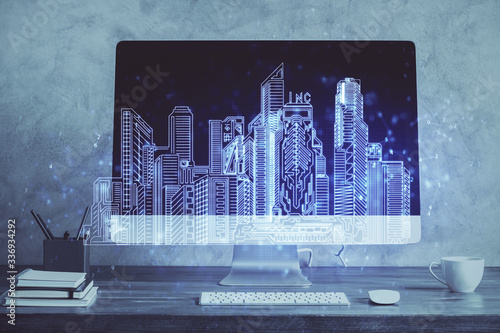Quadro su tela Desktop computer background in office and big town buildings hologram drawing