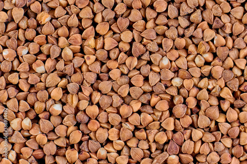 Macro photo of food buckwheat groats. Buckwheat grain background texture