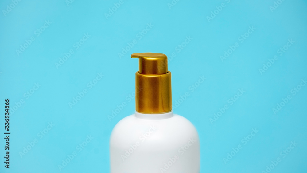 A bottle with an antiseptic, detergent, soap on a blue background. Hand disinfection. Disease Prevention Stay at home while in quarantine. coronavirus protection. Close-up.