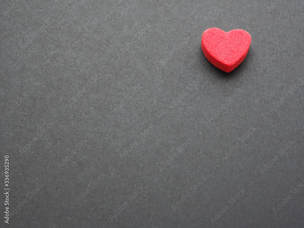 Red hearts on black paper background. There is space to put text, the concept for design.. Red hearts on black paper background. There is space to put text, the concept for design..