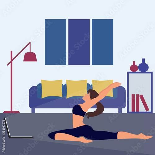 Woman doing yoga at home. Yoga online on the laptop during the coronavirus pandemic.