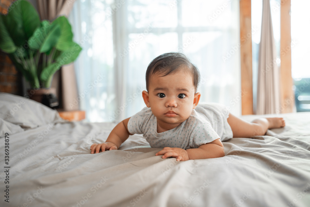 baby laying on the bed in the morning baby laying on the bed in the morning
