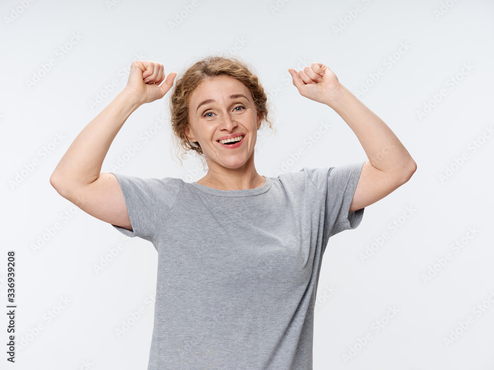 happy young woman with arms raised happy young woman with arms raised