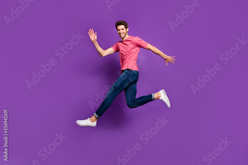 Full body photo of cheerful enthusiastic man jump see his girlfriend wave hand say hi wear good look youth style outfit shoes isolated over shine color background