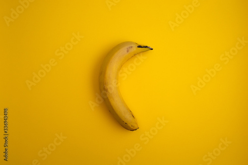 Top view of yellow banana with yellow background.