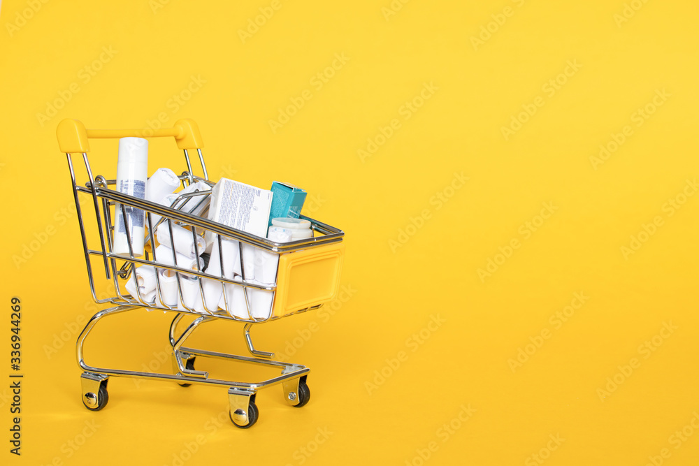 Full grocery cart on yellow background: place for text, banner, delivery of necessary medicinesduring and produts quarantine, epidemics, diseases, assistance. Delivery, online shop Full grocery cart on yellow background: place for text, banner, delivery of necessary medicinesduring and produts quarantine, epidemics, diseases, assistance. Delivery, online shop