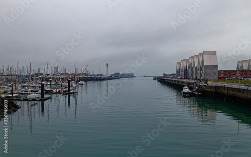 The Marina and moored Pilot Boat of the Port of Dunkirk with the Breakwater and Lighthouse in the background.