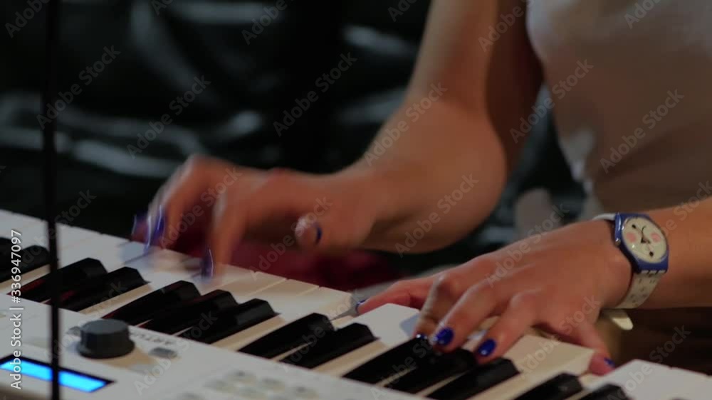 Woman hands play on keys closeup in slow motion Woman hands play on keys closeup in slow motion
