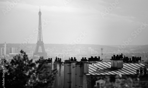 Cityscape of Paris over the rooftops with the Eiffel Tower on the background