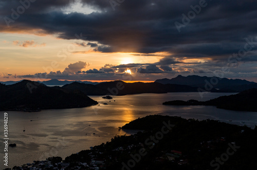 The sunset seen from a high pointview of Coron Island, Palawan, Philippines, on a cloudy day photo