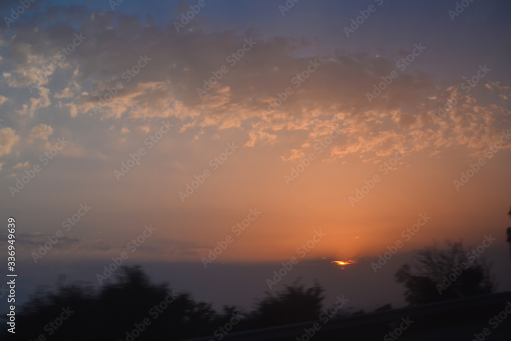 Sunset in the mountains on the road, in motion Sunset in the mountains on the road, in motion