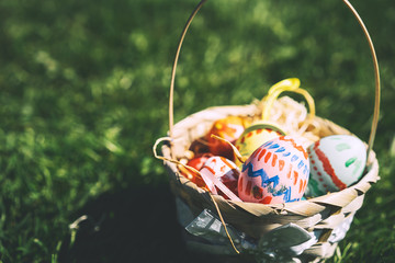 Painted easter eggs in wicker basket.