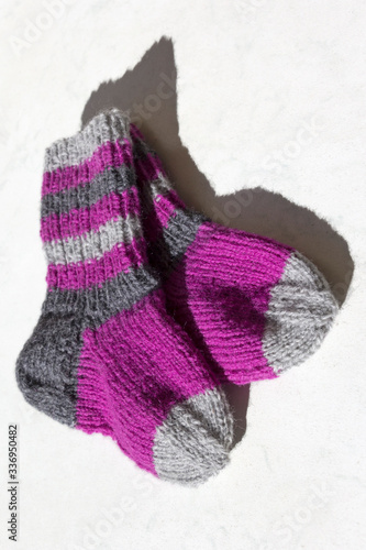 Obraz na płótnie Time for hobbies. Knitting socks with stripes for children and friends. w salonie