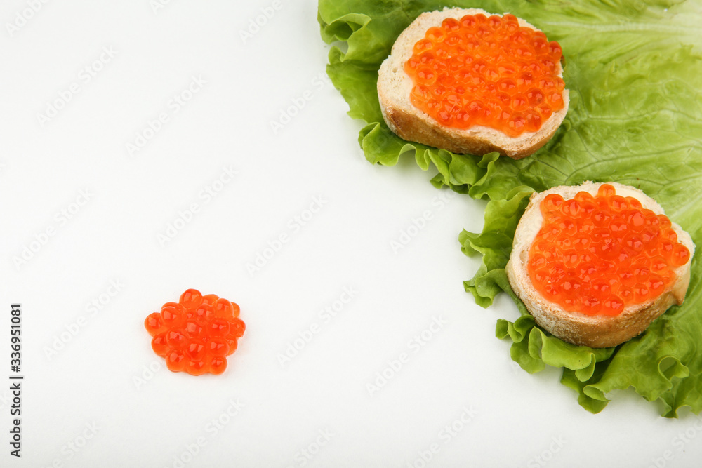 sandwiches with red caviar and lettuce on white background with copy space sandwiches with red caviar and lettuce on white background with copy space