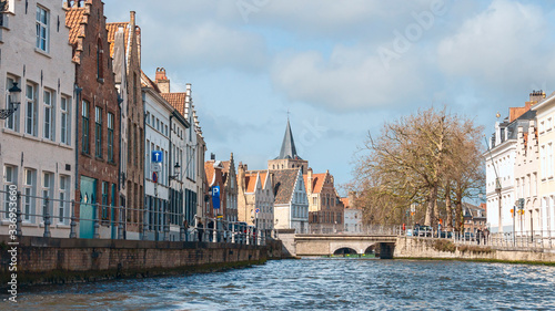 view of beautiful medieval houses on the stone promenade of the old Belgian city of Bruges
