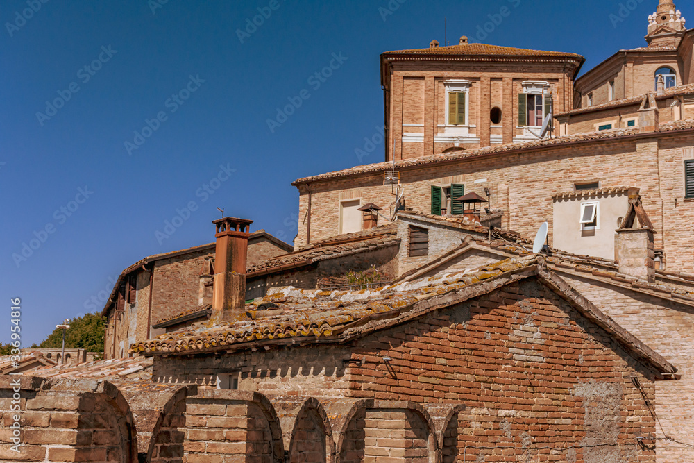 Looking up over the rooftops of Corinaldo, Le Marche, Italy on a clear and warm summer morning.