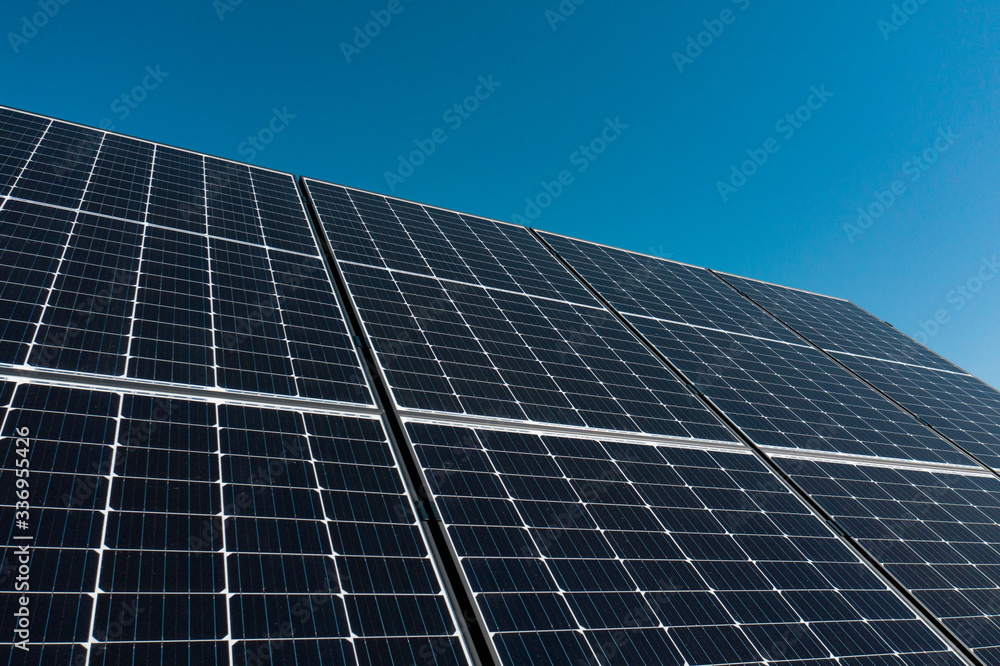 Background of photovoltaic modules for renewable energy. Huge solar panels with clear blue sky. Background of photovoltaic modules for renewable energy. Huge solar panels with clear blue sky.