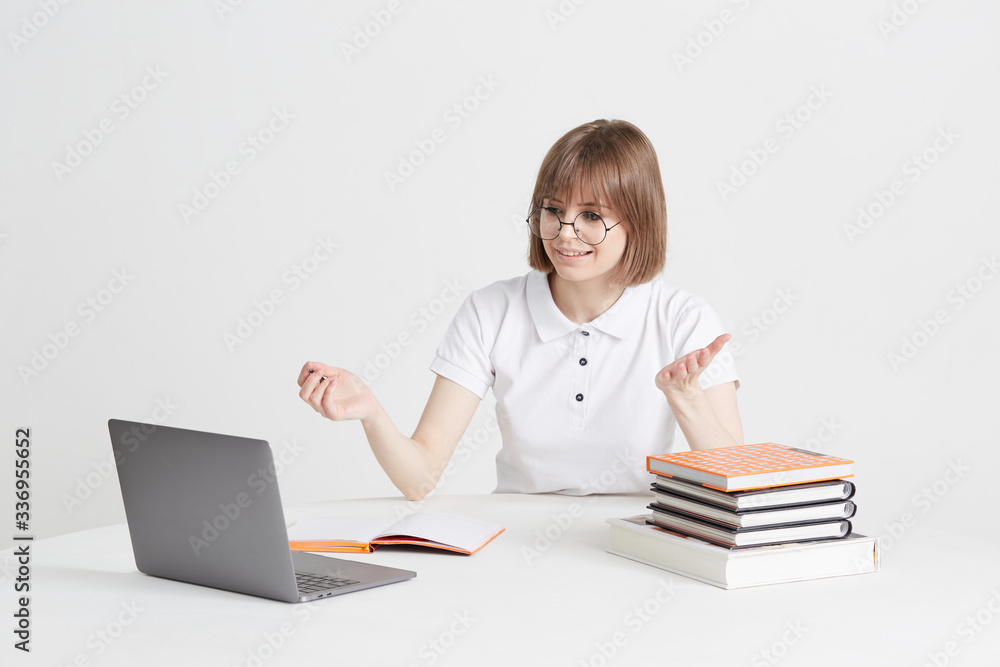 Cool happy girl goes through online training sitting at home. Remote school education on a laptop. Stay home lessons. Cool happy girl goes through online training sitting at home. Remote school education on a laptop. Stay home lessons.