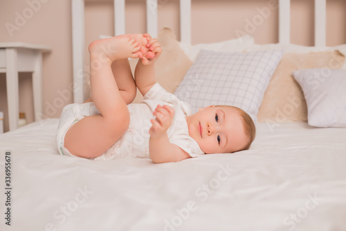 Cute baby crawling in bed. Good morning.
