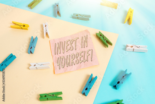 Text sign showing Invest In Yourself. Business photo text nvesting in a coach or a training to learn new things Colored clothespin paper empty reminder yellow blue floor background office photo