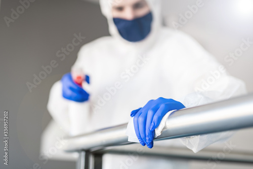 disinfection cleaning office - man in protective suit photo