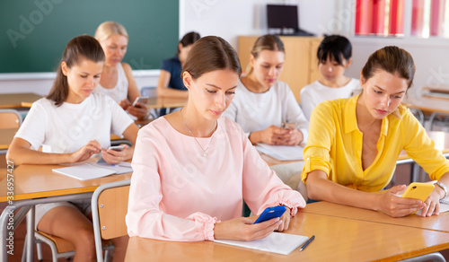 Students using smartphones during lesson