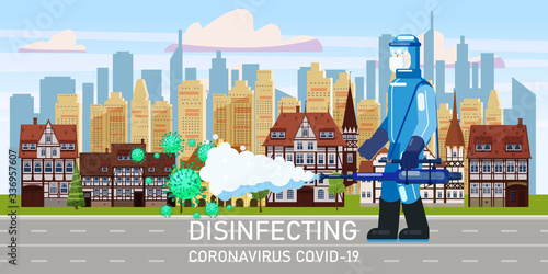 Man edical scientist in chemical protection suit disinfects spray to cleaning and disinfect virus Covid-19 in city downtown on street