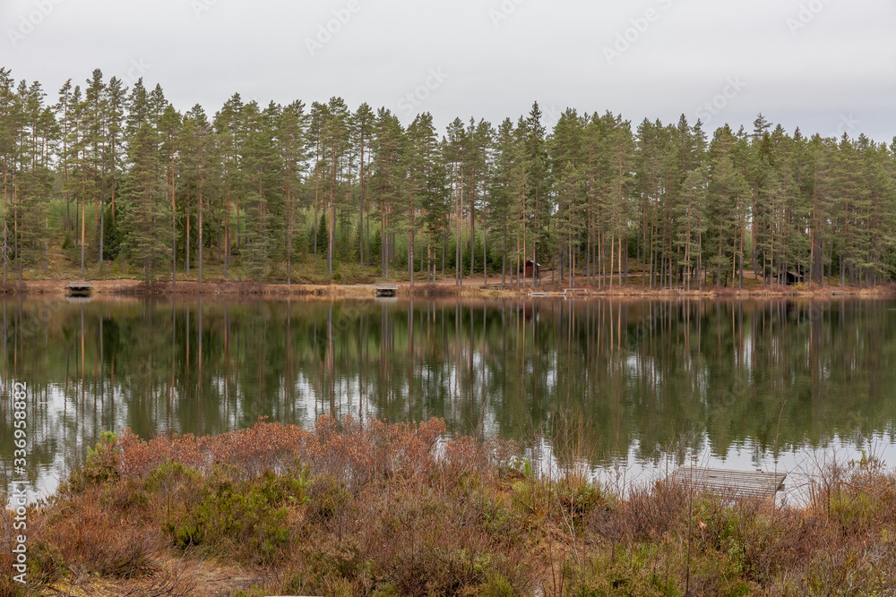 Lake, calm water, forest reflection in the water, cloudsAutumn landscape. Sweden. Lake, calm water, forest reflection in the water, cloudsAutumn landscape. Sweden.
