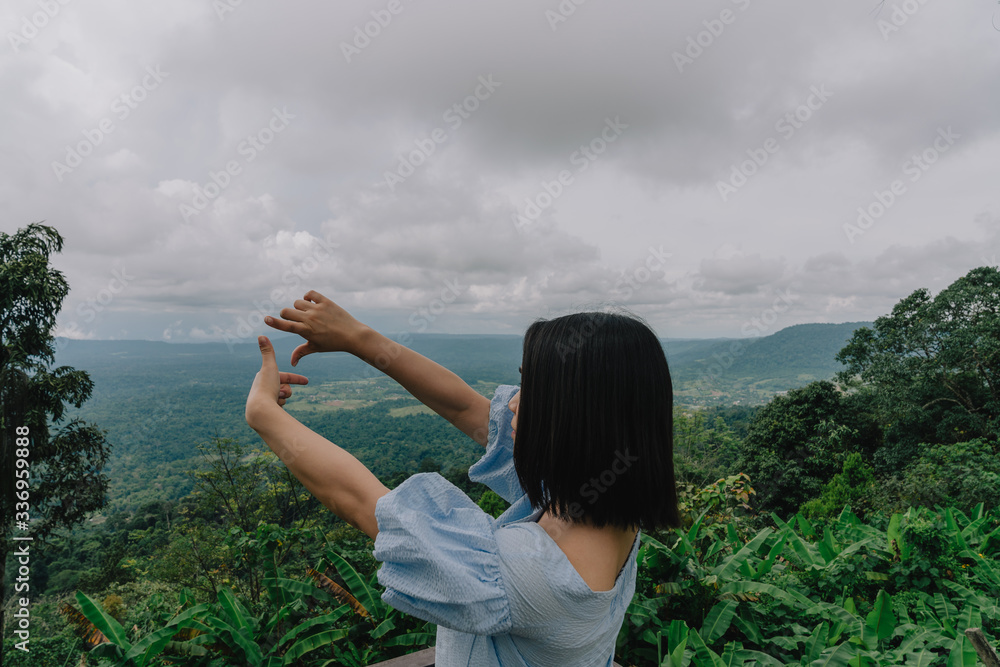 young cute Japanese Asian hipster girl travelling at beautiful sky 
mountains scenery park hiking garden views at Kanchanaburi Thailand guiding idea for female backpacker woman women backpacking
