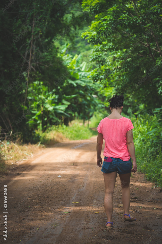young cute hipster girl travelling at beautiful Erawan waterfall mountains 
green forest hiking views at Kanchanaburi, Thailand. guiding 
idea for female backpacker woman women backpacking
