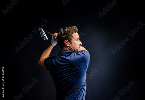 Close-up of a golf player intent on perfecting the swing photo
