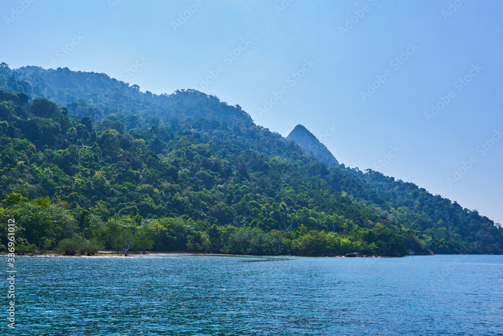 Tropical paradise beach with white sand and blue sky turquoise water and granite rocks travel tourism background concept. Amazing tropical holidays in paradise beaches of Tioman island, Malaysia.
