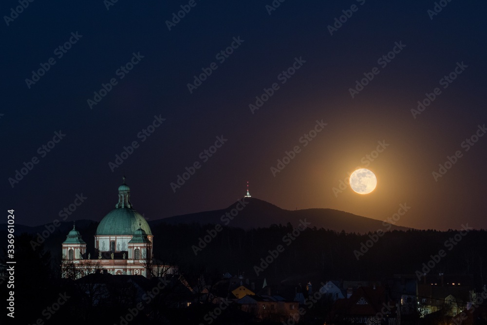 Basilica in Jablonne v Podjestedi and Jested, in the background is super moon in night landscape