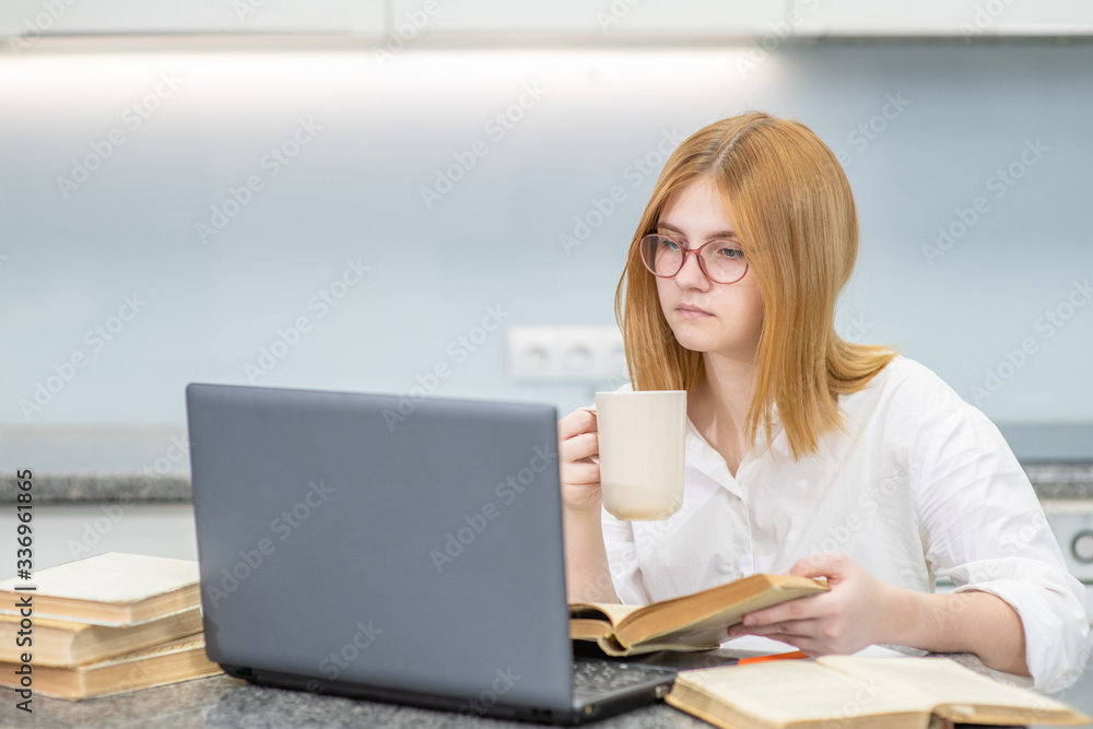 Girl is doing homework with laptop at home. Distance learning Girl is doing homework with laptop at home. Distance learning