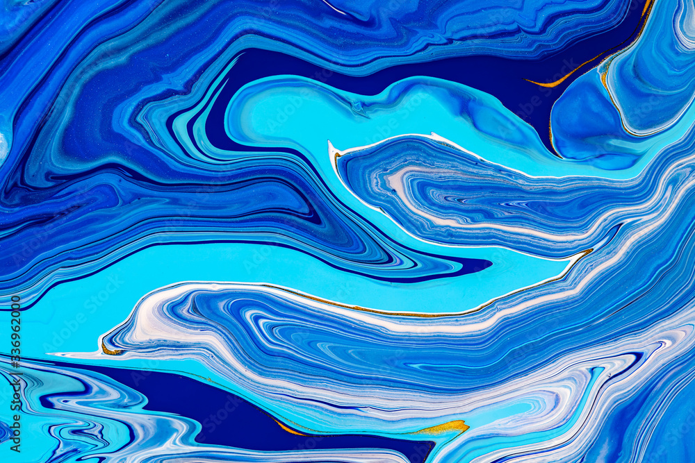 Fluid art texture. Abstract background with mixing paint effect. Liquid acrylic artwork with colorful mixed paints. Can be used for background or poster. Blue, golden and white overflowing colors.