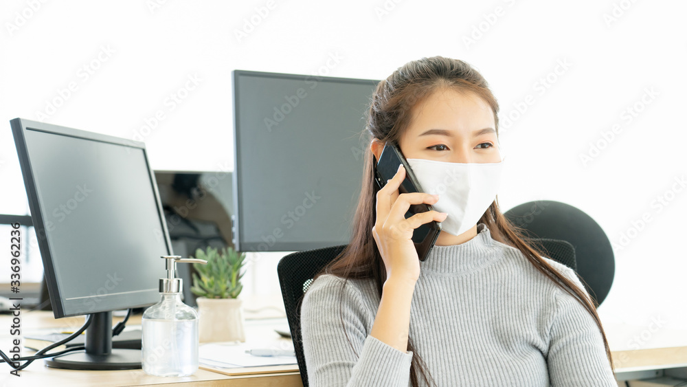 Woman wearing face mask protective for spreading of disease virus SARS-CoV-2 and hand wash cleaning by alcohol gel in office working for protection bacteria and virus, Covid-19 Coronavirus concept Woman wearing face mask protective for spreading of disease virus SARS-CoV-2 and hand wash cleaning by alcohol gel in office working for protection bacteria and virus, Covid-19 Coronavirus concept