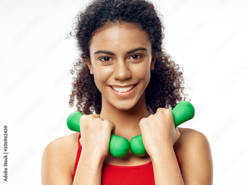 Sport girl with green dumbbells in hands Sport girl with green dumbbells in hands