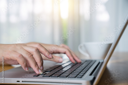 Cropped shot of a woman using a laptop while working from home
