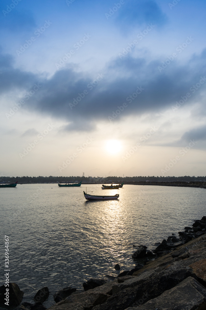 a view of Tanur harbor during surise with cloudy sky