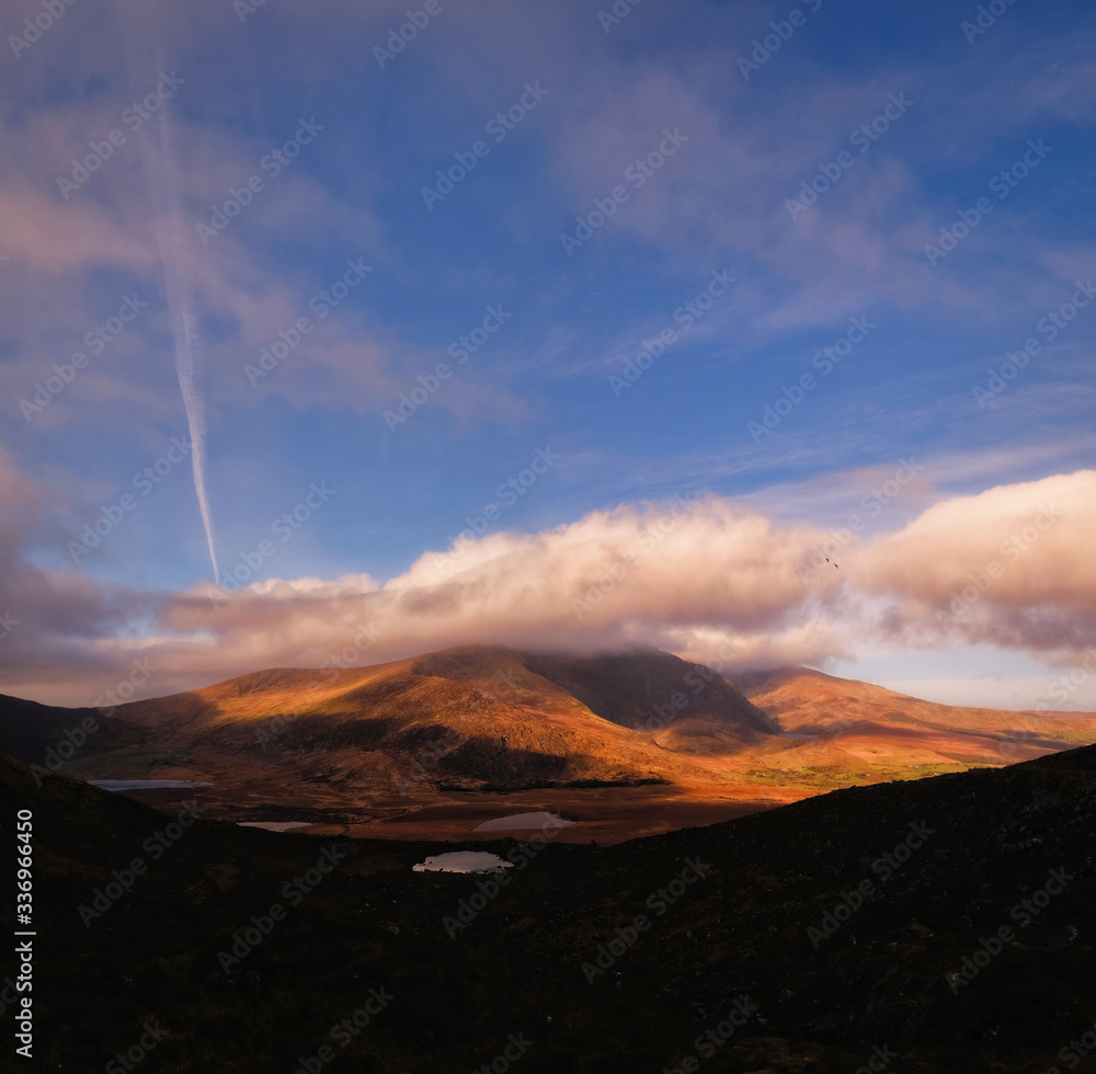 Scenic and breathtaking view of Brandon mountain ridge in sunset tones, with clouds and epic sky, Brandon mountain, Dingle Peninsula, Ireland