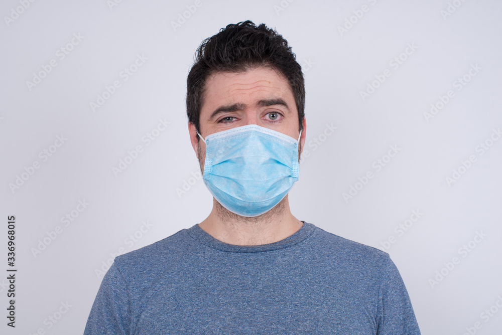 Handsome young man being nervous and scared biting lips looking camera with impatient expression, pensive� Handsome young man being nervous and scared biting lips looking camera with impatient expression, pensive�