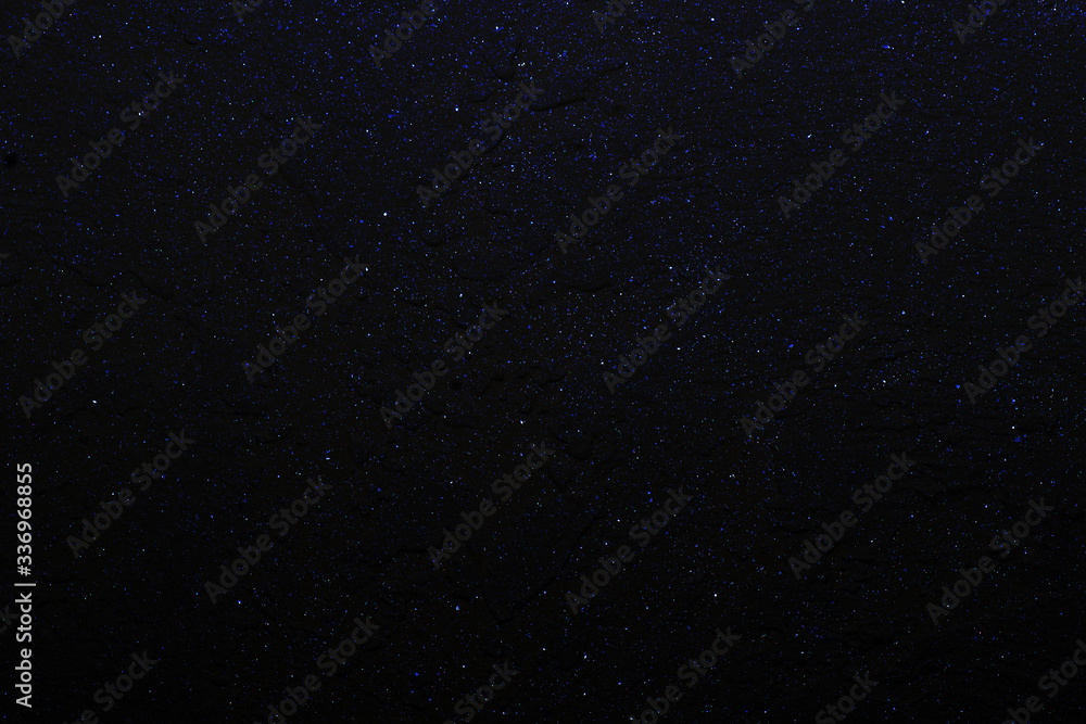 Abstract gorgeous bright dark blue background with multicolored glitter bokeh, similar to the night sky