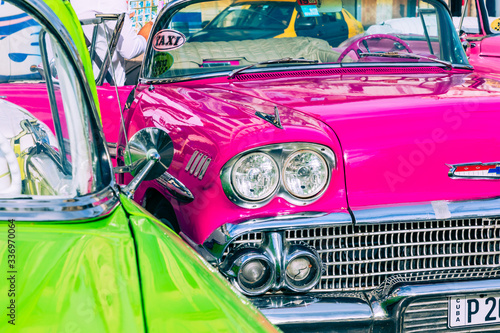Vintage classic american car in Havana, Cuba. Typical Havana urban scene with colorful buildings and old cars.
