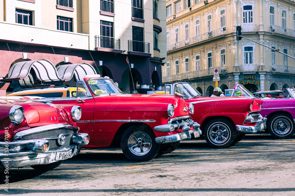 Vintage classic american car in Havana, Cuba. Typical Havana urban scene with colorful buildings and old cars.