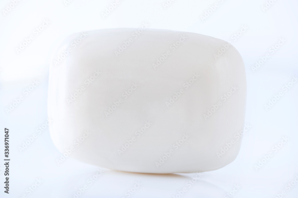 A bar of white soap on white background, close up , macro photography A bar of white soap on white background, close up , macro photography