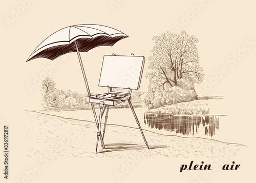 .Plein Air. Vintage image of the french style easel with a canvas, a palette, a brush and an umbrella on the river bank. Painting in the open air.